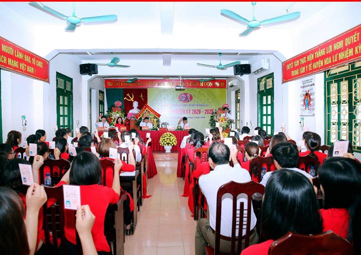 A group of people standing in front of a crowd  Description automatically generated